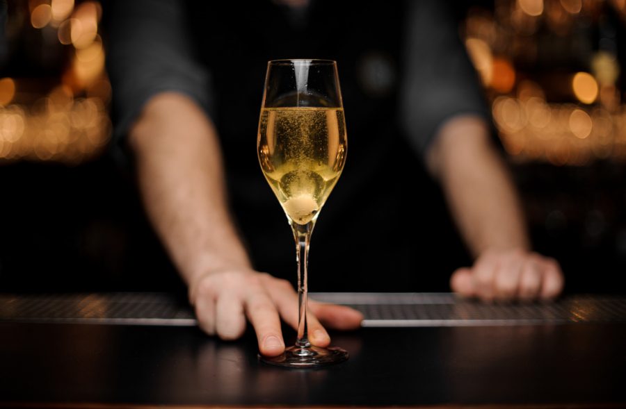 Close-shot-of-glass-with-sparkling-wine-in-the-bartender's-hands-1149484170_4117x2740